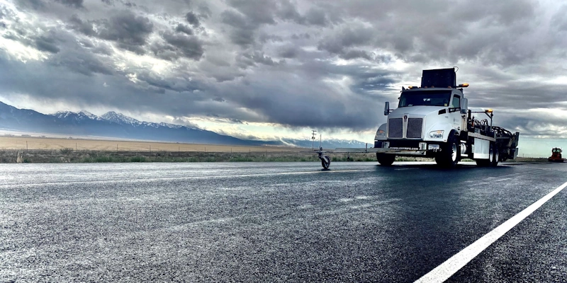 white rumble strip cutter in dark storm clouds weather
